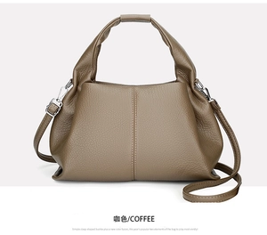 Macro detail of coffee brown litchi grain leather texture and metallic strap hardware