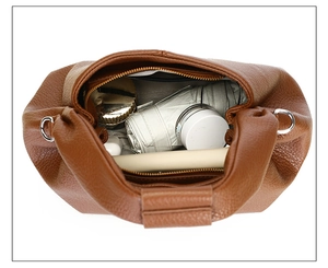 Interior view of brown lychee leather bag showing spacious storage for daily items