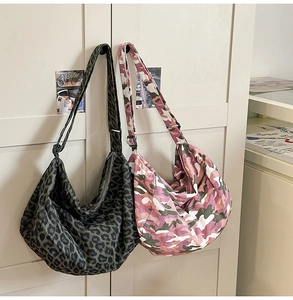 Detail of hobo canvas bags showing leopard print and camo patterns with adjustable straps