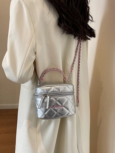 Chic silver quilted box bag with pink chain strap shown on a model in minimalist style