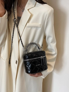 Classic black quilted box bag with silver chain strap shown as an elegant crossbody style