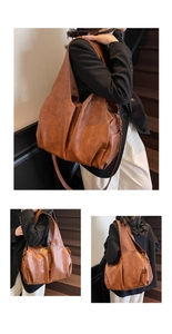 Detail view of large brown PU leather tote bag with soft folds and wide shoulder strap