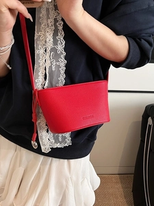 Red lychee texture bucket bag in a stylish minimalist crossbody style for women