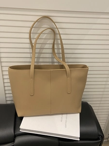 Minimalist beige faux leather tote bag with stylish stitching and large capacity
