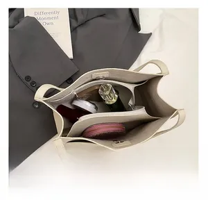 Internal view of beige faux leather tote bag showing spacious compartments and storage