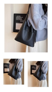 Detail of black lychee grain leather hobo bag showing pebble texture and side pocket