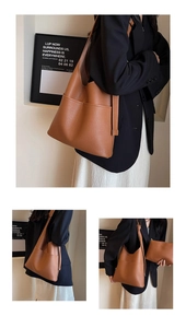 Close-up of brown litchi grain leather bucket bag with large pocket and matching pouch