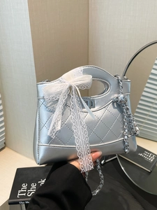 Silver quilted handbag with lace bow and metal ball chain strap, modern punk style