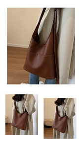 Close-up of brown faux leather tote bag with lychee texture and vertical stitching