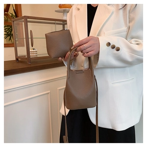 Close-up of litchi grain leather bucket bag with a matching zippered coin purse