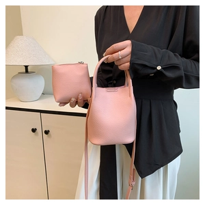 Detailed view of pink lychee texture bucket bag set including a matching small zipper pouch