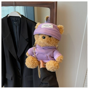 Detail of cute brown plush bear crossbody bag with purple hoodie and gold chain strap