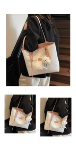 Detail of white large tote bag with pink straps and a cute plush cloud charm accessory