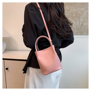 Detailed back view of pink lychee pattern bucket bag styled in a modern interior