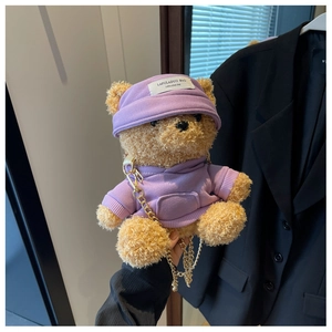 Detail of cute plush bear bag in purple hoodie with gold chain strap accessory