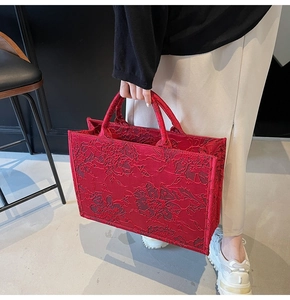 Macro shot of the red jacquard peony pattern on the luxury bridal wedding tote bag