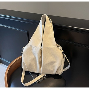 Close-up of cream lychee texture leather tote with wide handle and adjustable strap