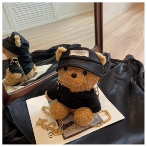 Close-up of a plush teddy bear crossbody bag featuring a black hoodie and gold chain