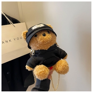 Detail view of teddy bear plush crossbody bag featuring brown faux fur and gold chain strap