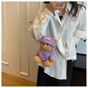 Detailed close-up of brown teddy bear plush bag with purple hoodie and golden chain strap