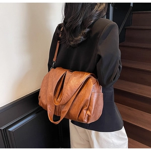 Detail of caramel large tote bag showing retro pleated texture and adjustable strap