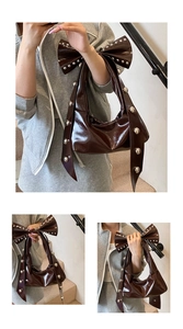 Detail der dunkelbraunen Lacktasche mit großer Schleife und silbernen Nieten-Verzierungen