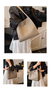 Detail view of the large capacity beige lychee grain leather tote bag with exterior pocket