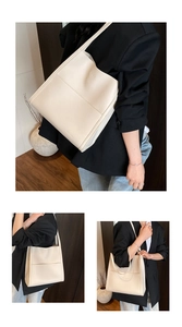 Detail of minimalist cream leather tote bag with grainy texture and logo for daily commute