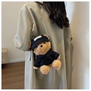 Detail of cute teddy bear plush bag with black hoodie and golden chain strap