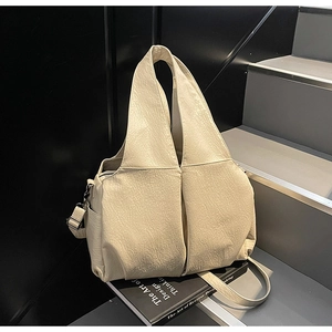 Detail of off-white large tote bag showing soft textured PU leather and wide shoulder strap