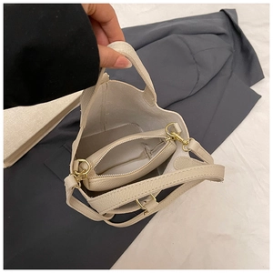 Detailed interior of beige lychee texture bucket bag showing the removable zip pouch