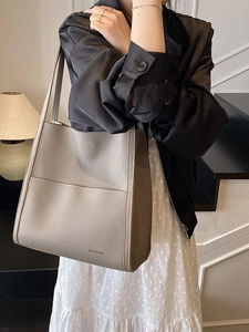 Large taupe lychee leather tote bag for women showing a minimalist commuter style