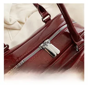 Macro shot of glossy burgundy cracked texture leather and silver double metal zippers