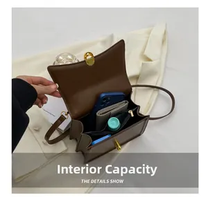 Detail view of large interior storage capacity for smartphone and wallet in brown crossbody bag