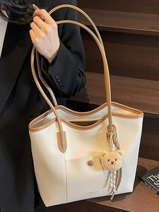 Large vintage tote bag in cream and brown leather with a cute plush bear pendant