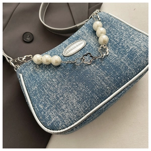 Blue denim crossbody bag with pearl flower chain strap and polished silver hardware