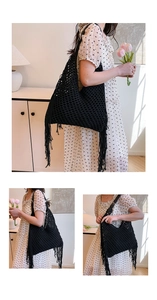 Detail of black crochet tote bag featuring long side tassels and hollow woven texture
