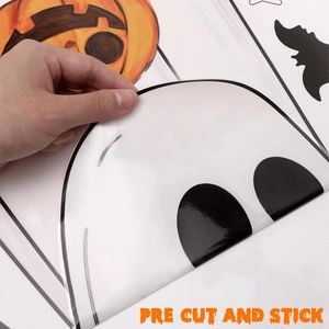 Detail showing pre-cut Halloween window stickers featuring cartoon ghosts and pumpkins