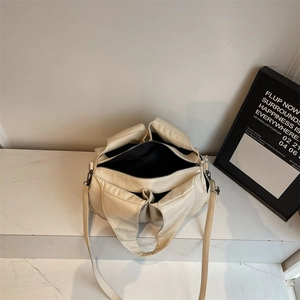 Minimalist creamy white large capacity shoulder bag with multi-pocket design and soft texture