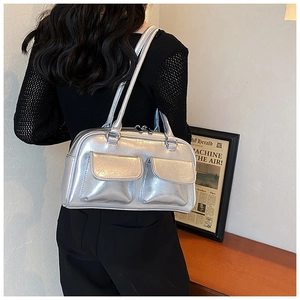 Silver metallic leather shoulder bag with dual front flap pockets shown from back view