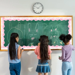 Pink cloud scalloped border trim applied to a classroom chalkboard with students