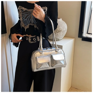 Detail view of the metallic silver underarm tote bag with double front zip pockets