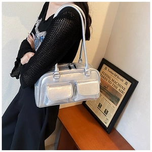 Detailed close-up of metallic silver tote bag with double front utility pockets and texture