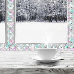 Holographic snowflake border decoration on window with warm winter holiday cozy aesthetic