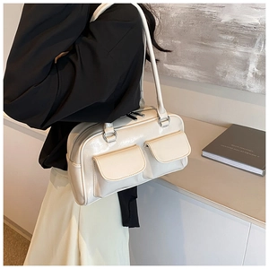 Detail of creamy white Y2K style tote bag with dual flap pockets and silver hardware