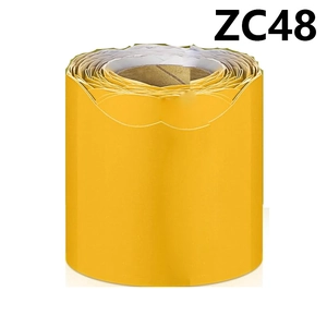 Macro shot of bright yellow scalloped bulletin board border trim roll for classroom display