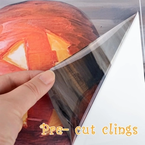 Pre-cut Halloween pumpkin window cling being peeled off for festive home decoration