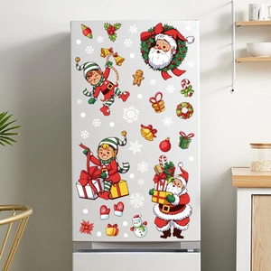 Detail of Santa and gingerbread man decals on a white fridge in a bright kitchen