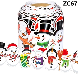 Detail showing various cartoon snowman stickers on a roll for Christmas decoration