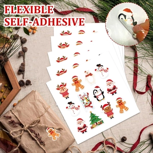 Detail of flexible self-adhesive Christmas stickers with Santa and reindeer on rustic linen